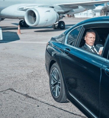 Luxury limo passenger beside private jet at Toronto airport
