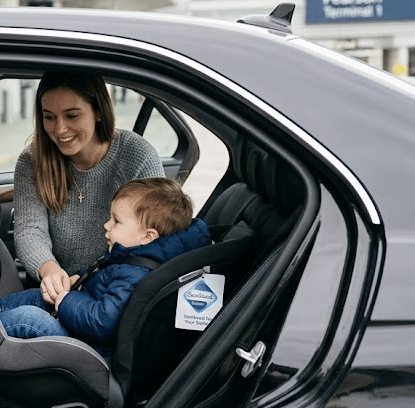 Professional airport taxi with premium car seat installed, Toronto Pearson Terminal 1.