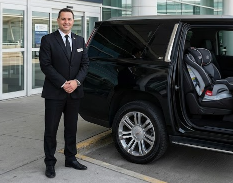Toronto Pearson Airport taxi driver waiting at terminal with pre-installed child car seat