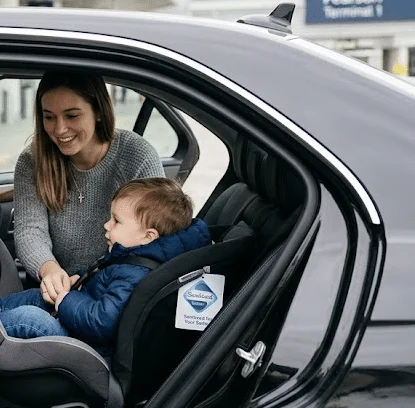 Professional airport taxi with premium car seat installed, Toronto Pearson Terminal 1.